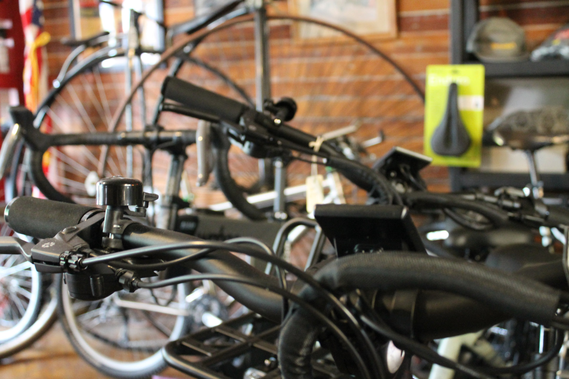 Close-up of bicycle handlebars and bells inside the shop